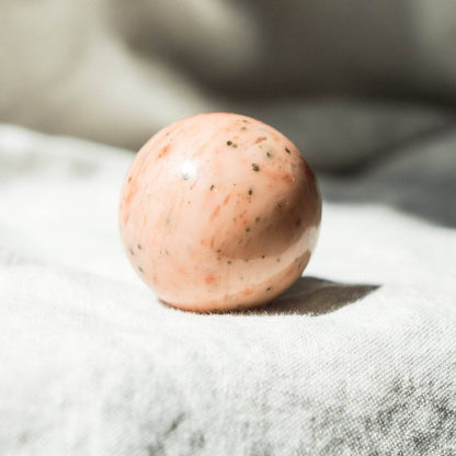 Orange Calcite Sphere with Tripod by Tiny Rituals