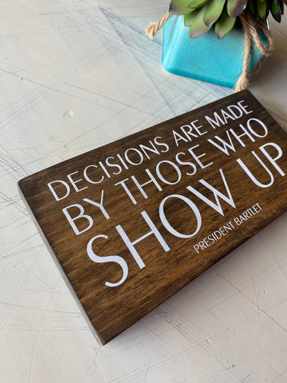 Decisions are made by those who show up. by Novotny Designs